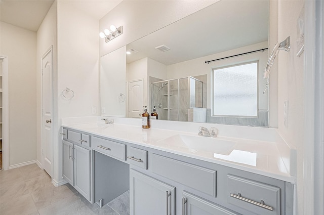 bathroom with tile patterned flooring, vanity, and a shower with door