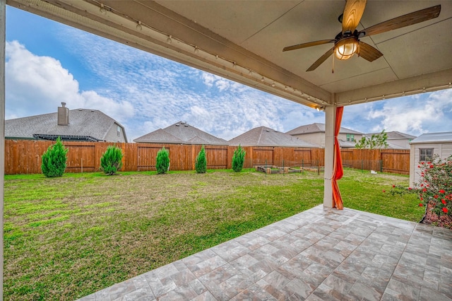 view of yard with ceiling fan and a patio area