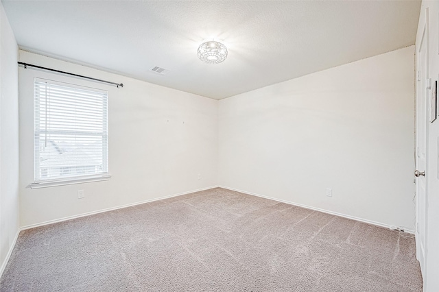 unfurnished room featuring light colored carpet