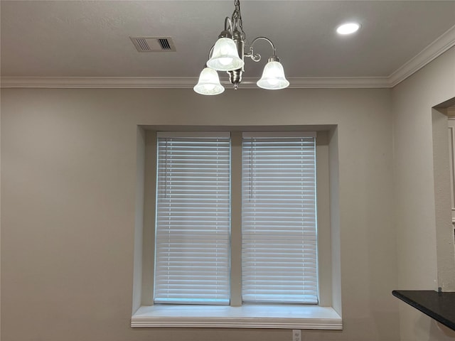 details with crown molding and an inviting chandelier