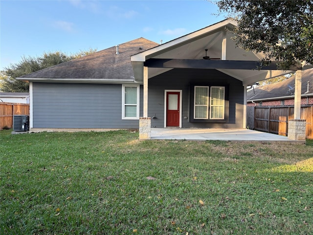 rear view of house featuring a yard, a patio, and central AC unit