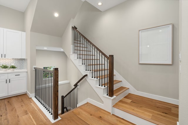 stairs featuring hardwood / wood-style flooring