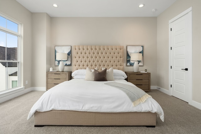 bedroom with carpet floors and multiple windows