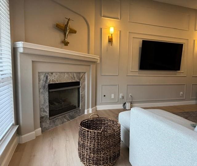 living room with hardwood / wood-style floors and a fireplace