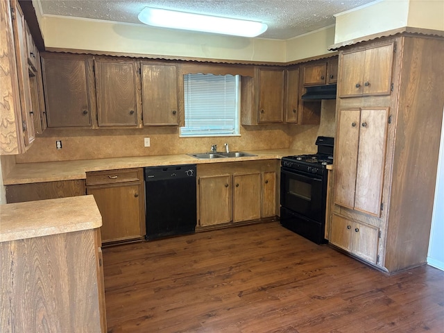 kitchen featuring decorative backsplash, a textured ceiling, sink, black appliances, and dark hardwood / wood-style floors