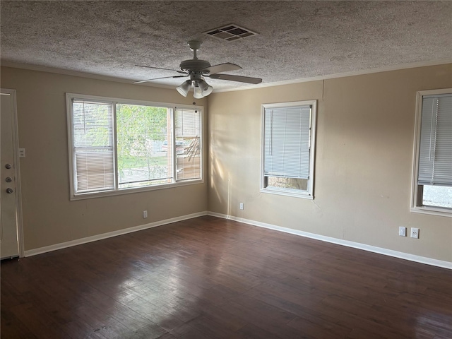 empty room with a textured ceiling, ceiling fan, and dark hardwood / wood-style floors