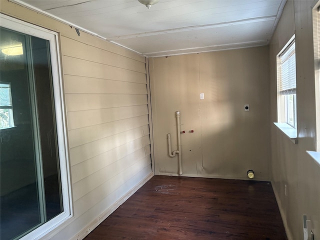 laundry room with wooden walls, dark hardwood / wood-style floors, and hookup for an electric dryer