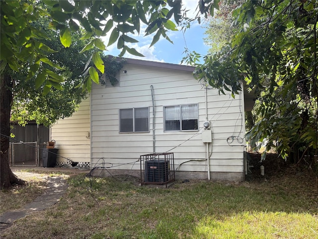 view of home's exterior featuring central AC and a yard