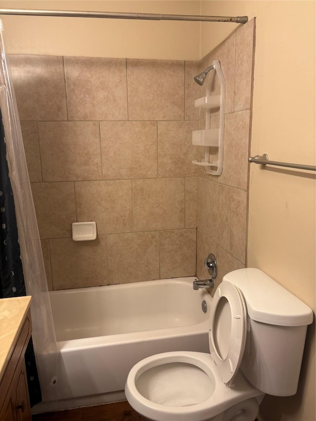 full bathroom featuring vanity, shower / bath combination with curtain, and toilet