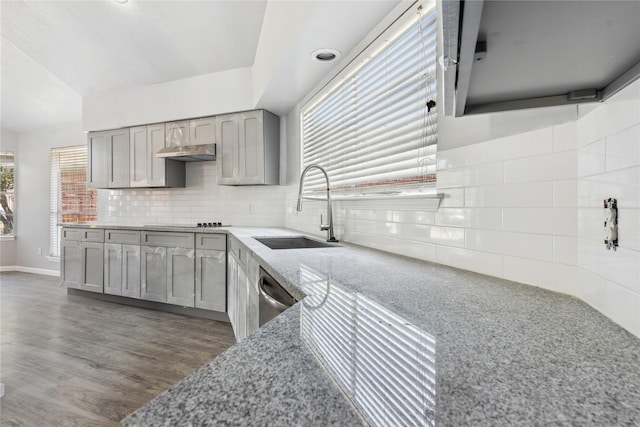 kitchen with gray cabinets, dishwasher, sink, and a healthy amount of sunlight