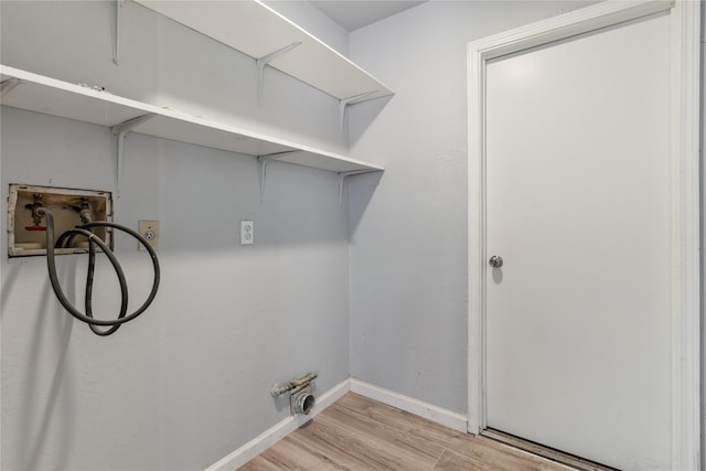 clothes washing area with hookup for a washing machine and light wood-type flooring