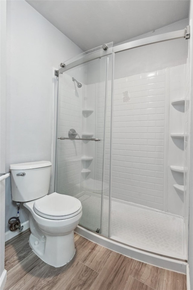 bathroom featuring toilet and walk in shower