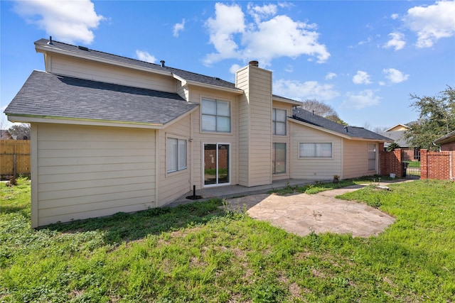 rear view of property with a patio and a lawn