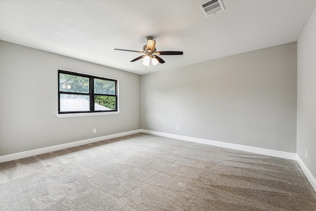 spare room featuring carpet and ceiling fan