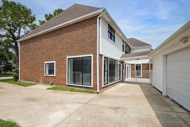 view of home's exterior featuring a patio and a garage