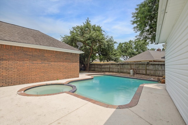 view of swimming pool with an in ground hot tub and a patio