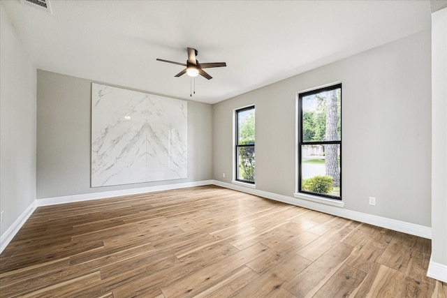 empty room featuring hardwood / wood-style floors and ceiling fan