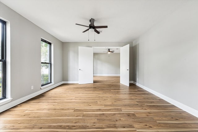 empty room with light hardwood / wood-style flooring and ceiling fan