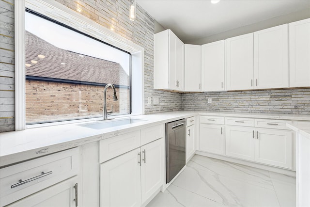 kitchen featuring dishwasher, backsplash, white cabinets, and sink