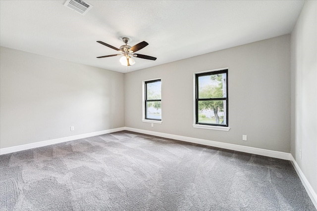 carpeted spare room with ceiling fan