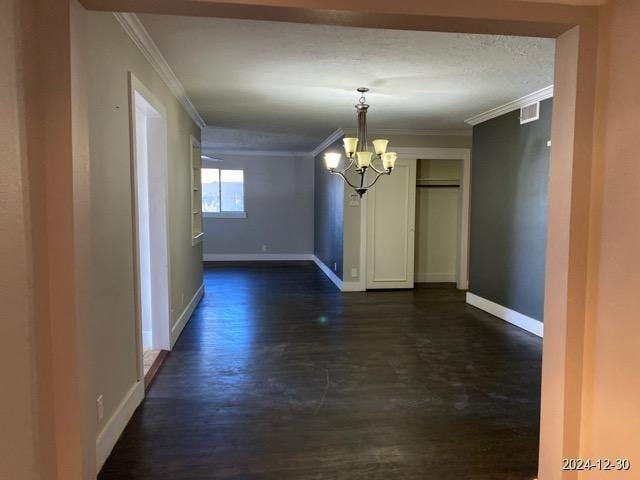 hall featuring an inviting chandelier and crown molding