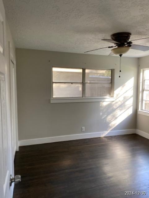 spare room featuring a textured ceiling, dark hardwood / wood-style floors, and ceiling fan