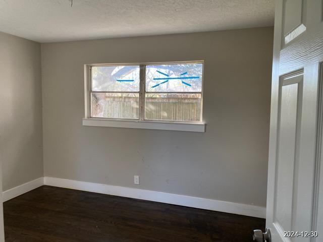 spare room featuring dark hardwood / wood-style floors