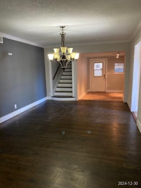 interior space featuring a chandelier, dark wood-type flooring, and crown molding