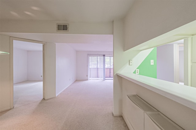 hallway featuring light carpet