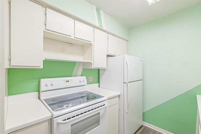 kitchen with white appliances and white cabinetry