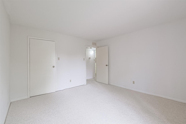 spare room featuring light colored carpet