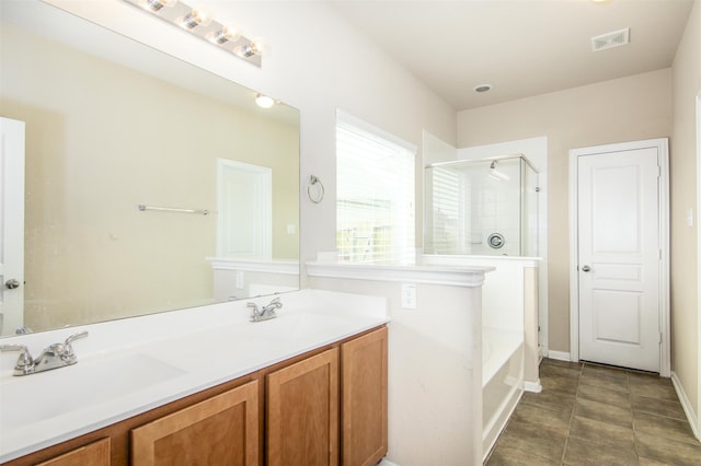 bathroom with tile patterned flooring, vanity, and independent shower and bath