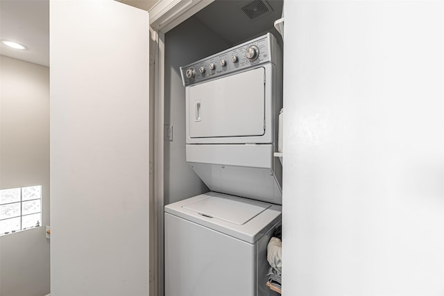 laundry room featuring stacked washer / dryer