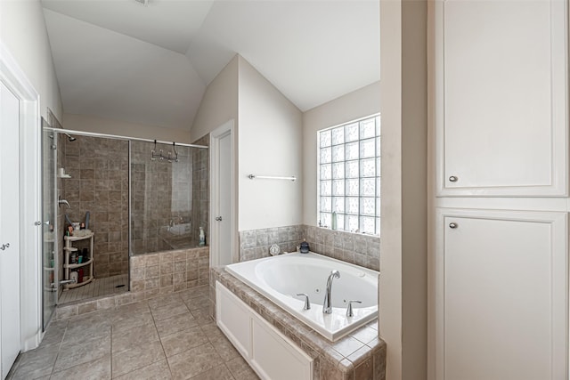 bathroom with tile patterned flooring, lofted ceiling, and shower with separate bathtub