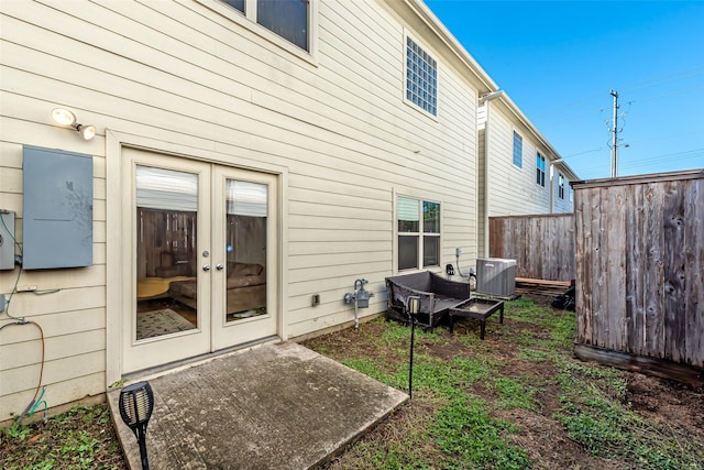 rear view of property with french doors, a patio, and central AC unit