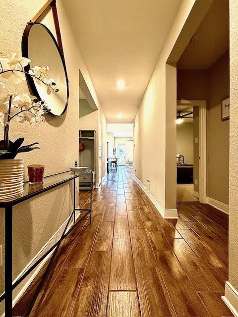 corridor featuring dark wood-type flooring