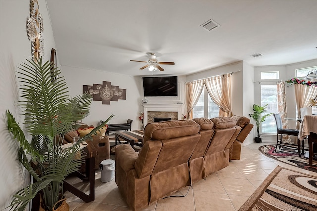 living room featuring ceiling fan and light tile patterned flooring