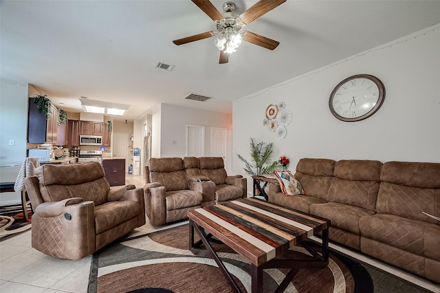 living room featuring ceiling fan and light tile patterned floors