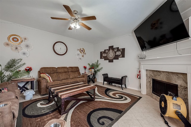 living room with ceiling fan, light tile patterned floors, and a fireplace