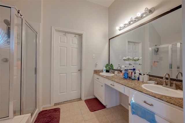 bathroom featuring vanity, tile patterned floors, and walk in shower