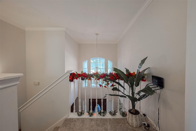 staircase with a chandelier and ornamental molding