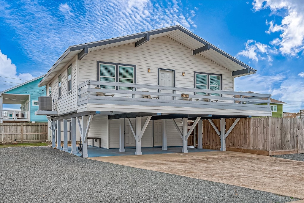 view of front of house with cooling unit and a carport