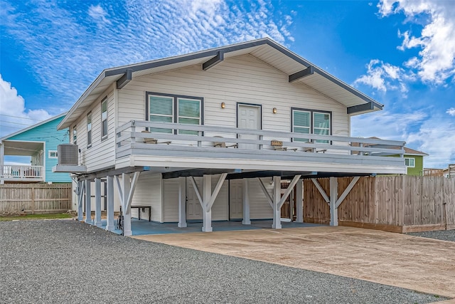 view of front of house with cooling unit and a carport