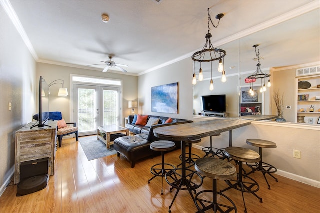 living room featuring ceiling fan, light hardwood / wood-style flooring, french doors, and ornamental molding