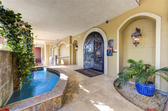 view of swimming pool with french doors