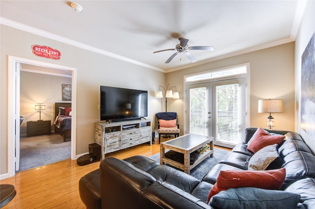 living room with ceiling fan, light hardwood / wood-style flooring, french doors, and ornamental molding