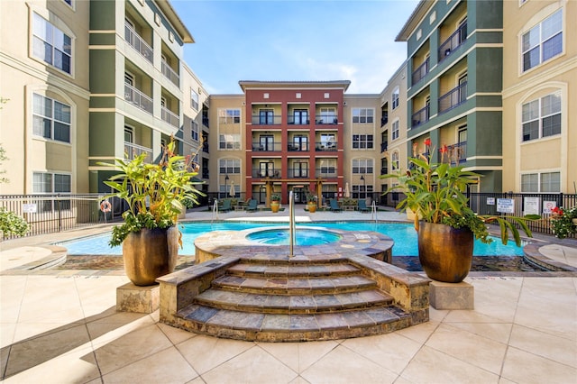 view of swimming pool with a hot tub