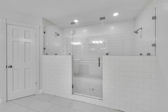 bathroom featuring tile patterned floors and a shower with shower door