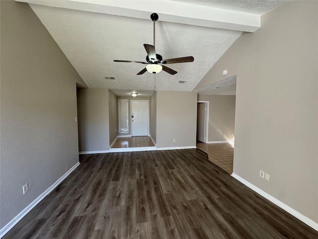 unfurnished living room featuring vaulted ceiling, ceiling fan, dark hardwood / wood-style flooring, french doors, and a textured ceiling