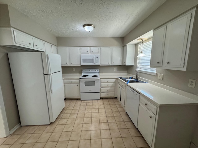 kitchen with white appliances, white cabinetry, a textured ceiling, and sink